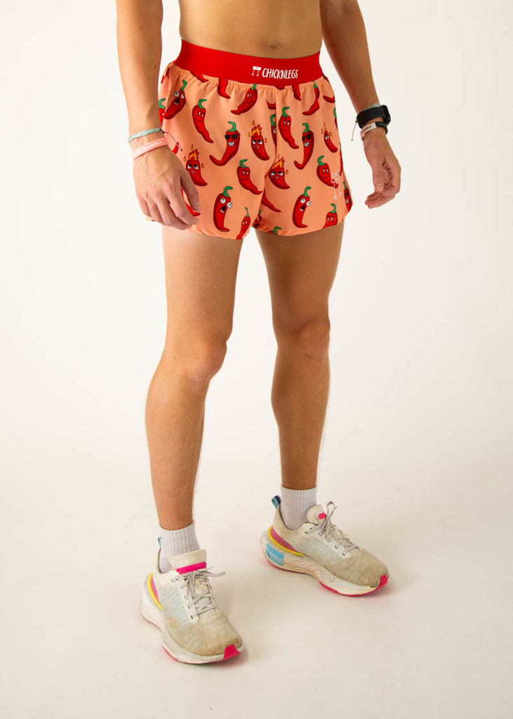 Model is a runner wearing Chicknlegs 4 inch split running shorts in the Chili Pepper design, facing right.
