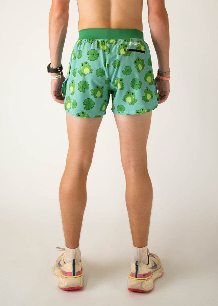 Model is a runner wearing Chicknleg's men's 4 inch split running shorts in the fartlek frog design, facing away from the camera to show the back of the shorts.
