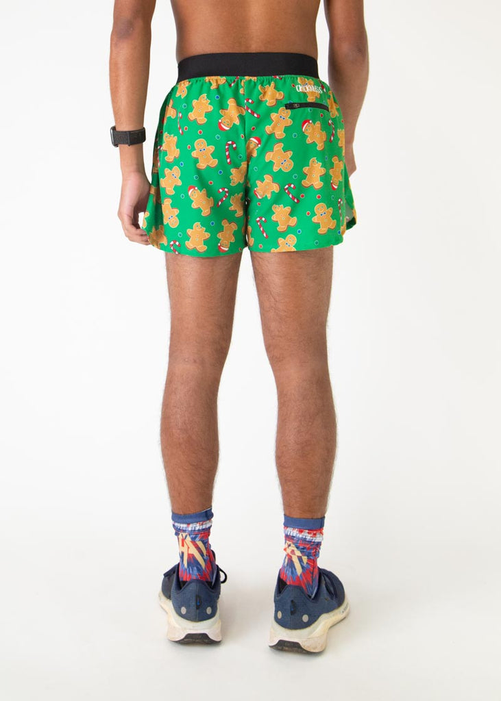 The model is a runner who is wearing Chicknlegs in men's 4 inch split running shorts in the Gingerbread Men's Gingy's Revenge design, facing away from the camera to show the back of the shorts.