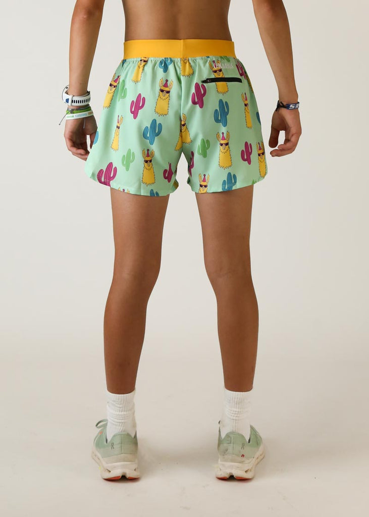 Model wearing Chicknlegs men's 4 inch split running shorts green llama design back view