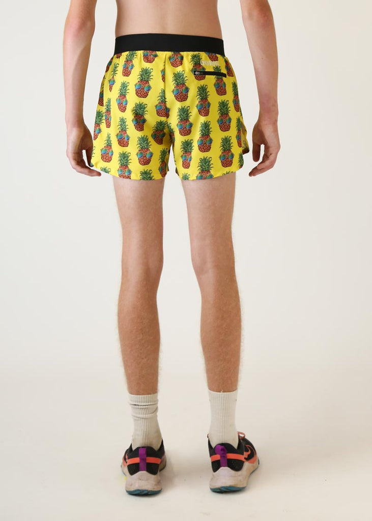 Model wearing Chicknlegs men's 4 inch split running shorts pineapple express design back view