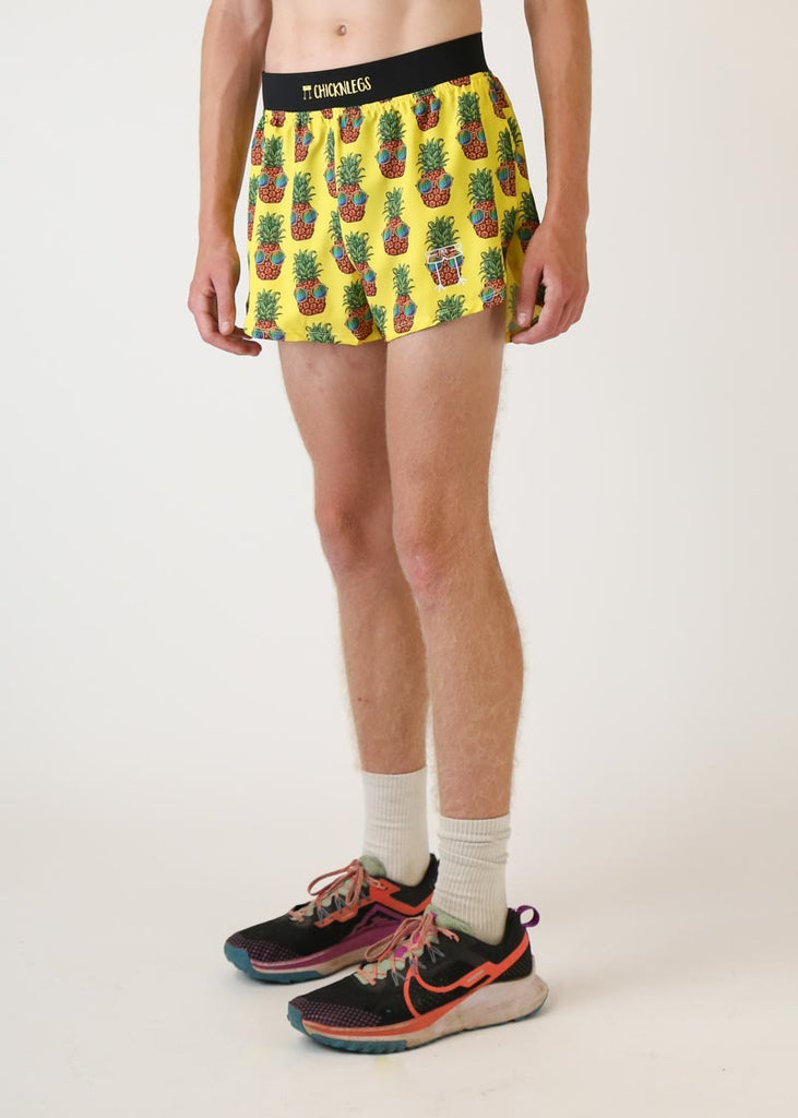 Model wearing Chicknlegs men's 4 inch split running shorts pineapple express design left view