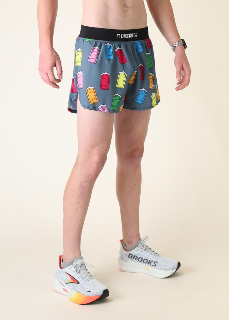 Model wearing Chicknlegs men's 4 inch split running shorts in the porta potty design facing right for side view.