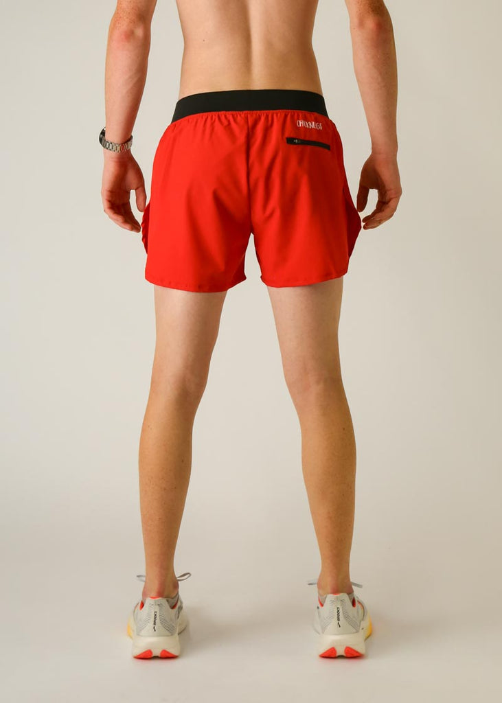 Model is wearing Chicknlegs men's 4 inch split running shorts in the red design, facing away from the camera to see the back view.
