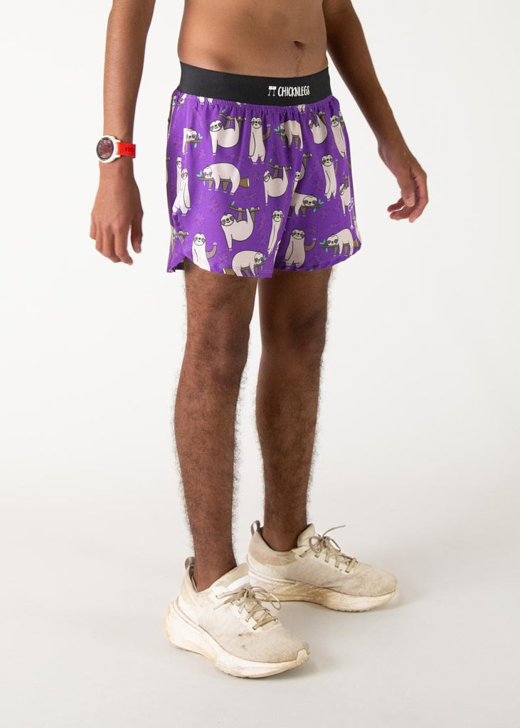 The model is a runner who is wearing Chicknlegs men's 4 inch split running shorts in the sloth design, facing right.