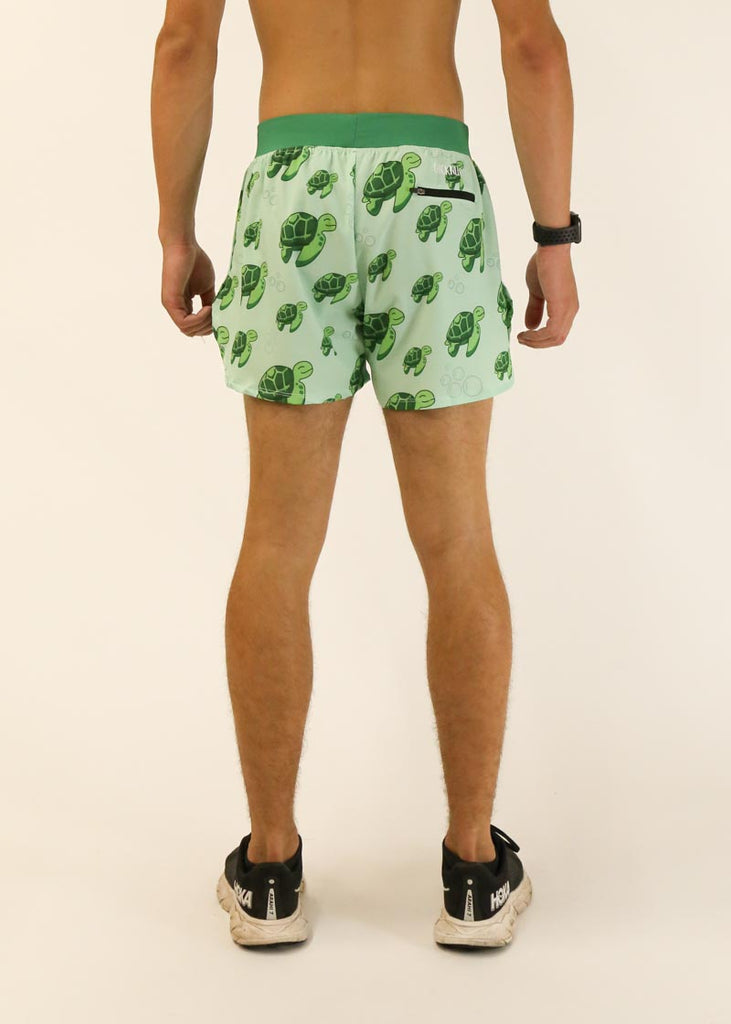 Model is a runner who is wearing Chicknlegs men's 4 inch split running shorts in the turtles design, facing away from the camera to show the back of the shorts.