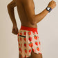 Side view of runner wearing the strawberry szn 4 inch split running shorts.