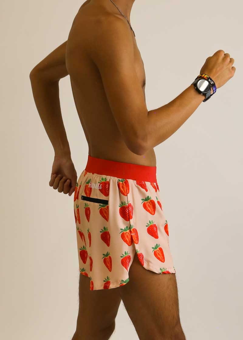 Side view of runner wearing the strawberry szn 4 inch split running shorts.