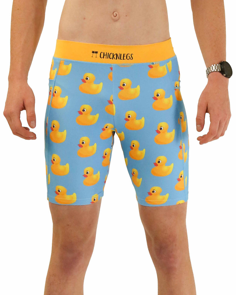 Runner is wearing ChicknLegs in the men's 8 in half tights with pockets in the rubber duckys design. The print has fun yellow rubber ducks on it with a solid blue background.