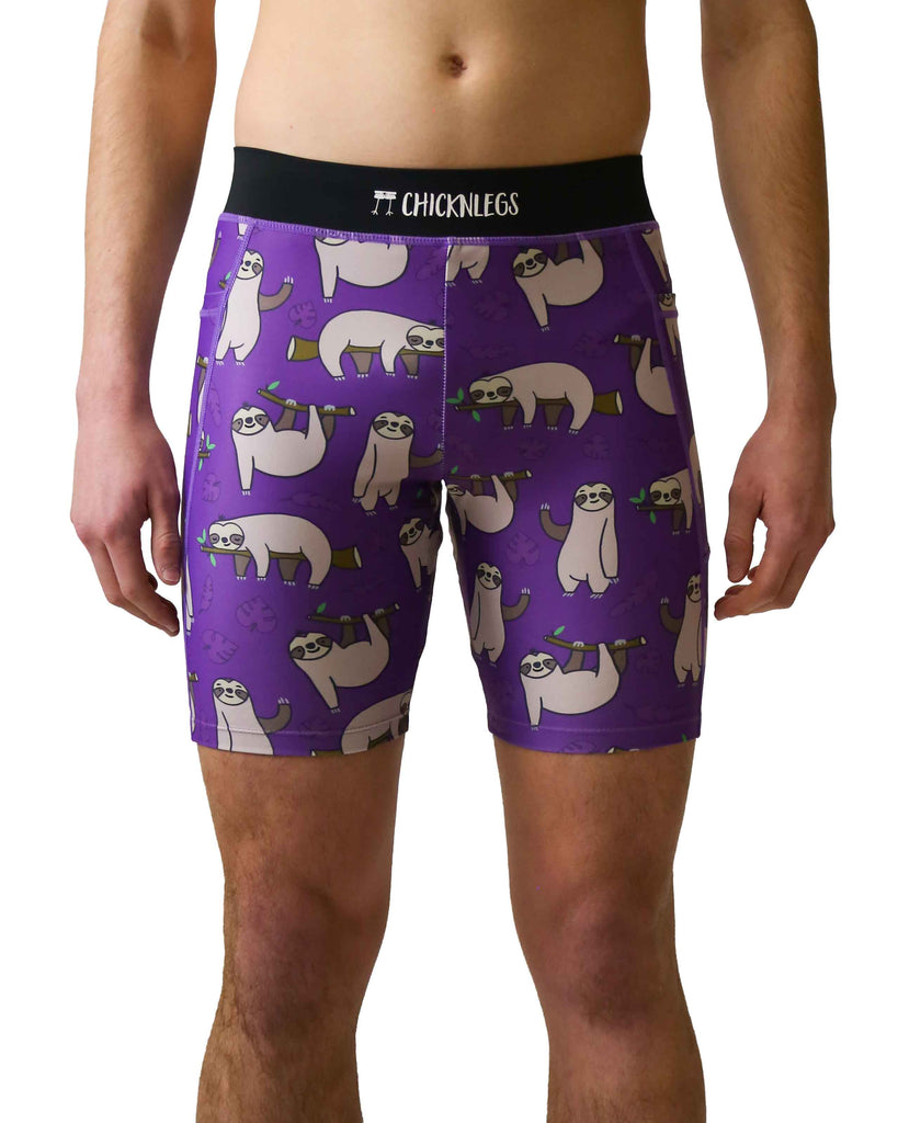 Runner is wearing ChicknLegs in the men's 8 in half tights with pockets in the sloth design. The print has fun sloths all over it with green leaves and branches on a solid purple background.