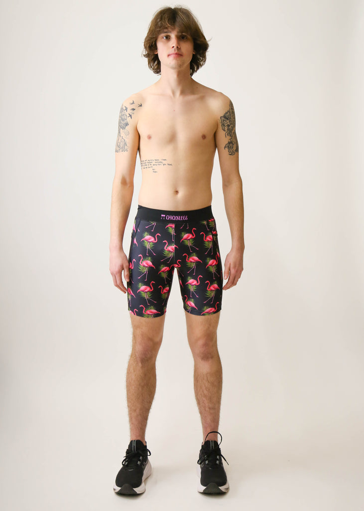 Model is a runner wearing Chicknlegs men's 8 inch half tight with the black flamingo design, facing front.