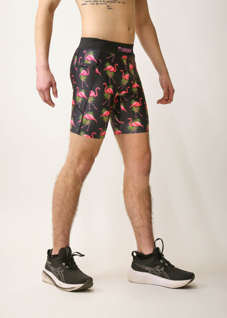 Model is a runner wearing Chicknlegs men's 8 inch half tight with the black flamingo design, facing right.