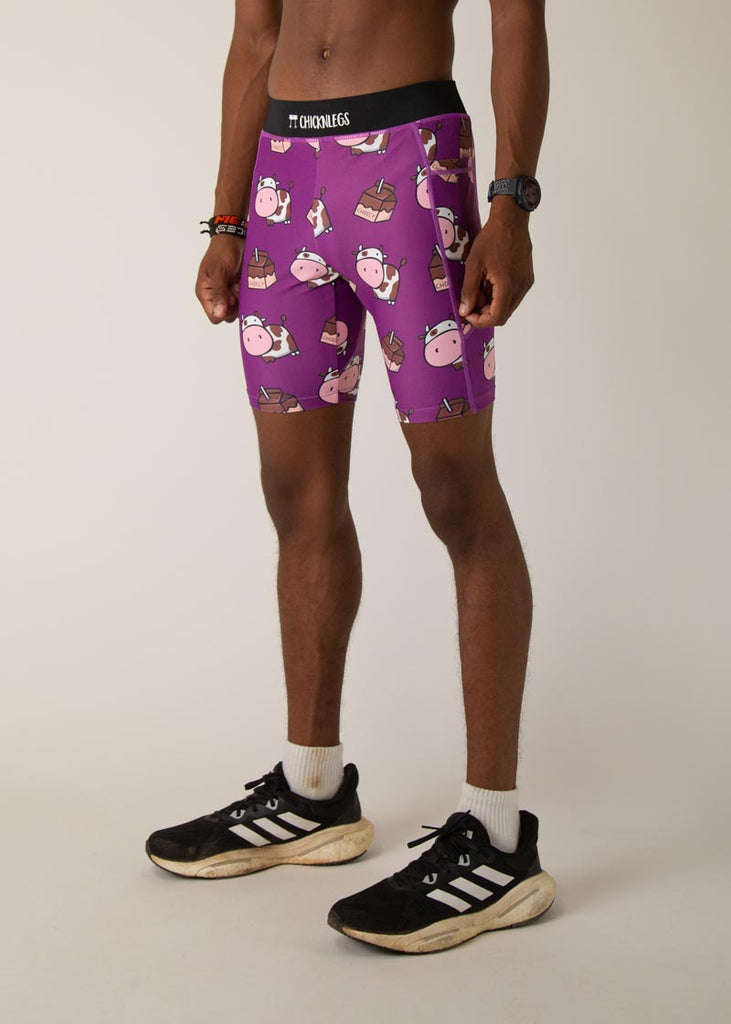 Model wearing Chicknlegs men's 8 inch half tights in the choccy cow design, facing left.