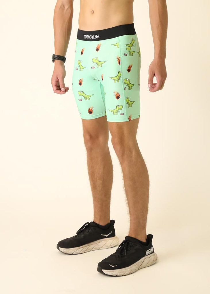 Model wearing Chicknlegs men's 8 inch half tights in the dino's design facing left for side view.