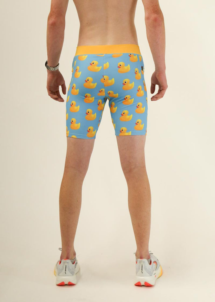 Model wearing Chicknlegs men's 8 inch half tights in the rubber ducky design facing back for behind shot.