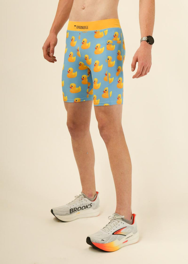 Model wearing Chicknlegs men's 8 inch half tights in the rubber ducky design facing left for side view.