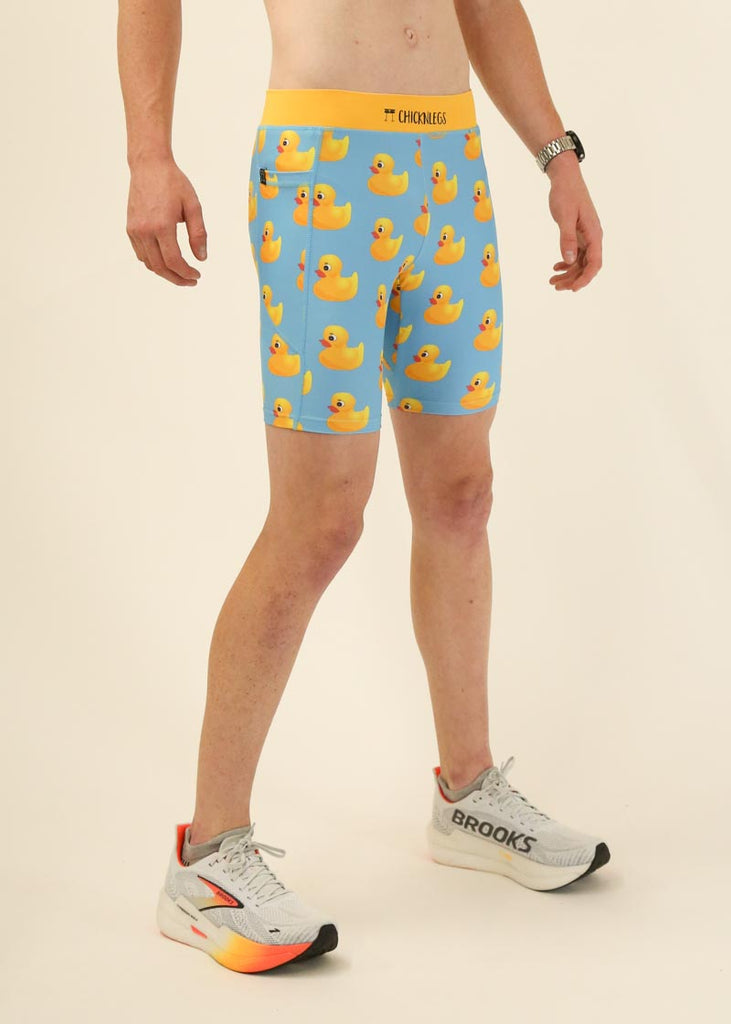 Model wearing Chicknlegs men's 8 inch half tights in the rubber ducky design facing right.