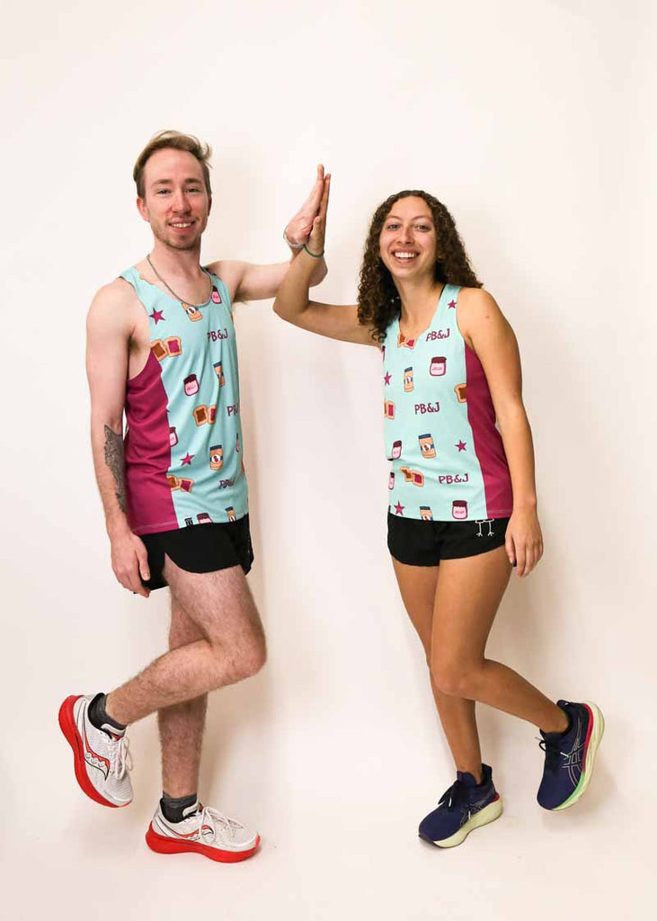 Runners wearing the men's and women's PB&J performance singlets and split shorts.