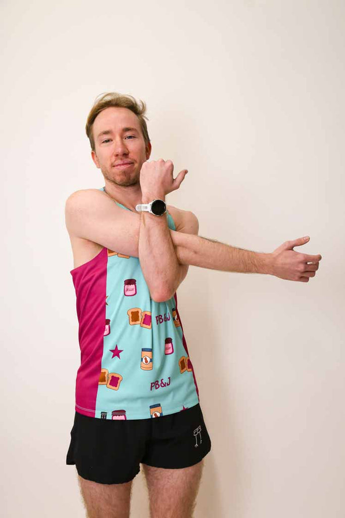 Runner stretching while wearing the men's PB&J performance singlet.