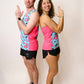 Runners smiling while doing James Bond pose while wearing the blue flamingo performance singlets.