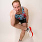 Runner doing a goofy stretch while wearing the ChicknLegs men's blue flamingo singlet.
