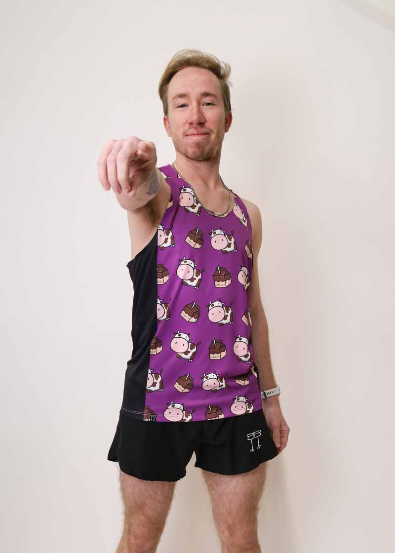 Runner pointing to camera while wearing the men's black split shorts and choccy cows performance running singlet.