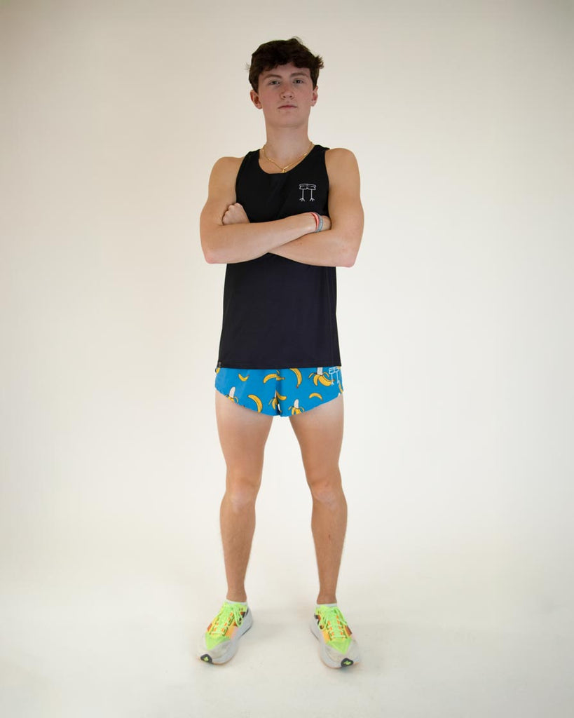 Full body view of model wearing the ChicknLegs Performance Running Singlet in the solid black color, featuring lightweight, breathable construction with mesh back panel and seamless armholes for a comfortable fit.