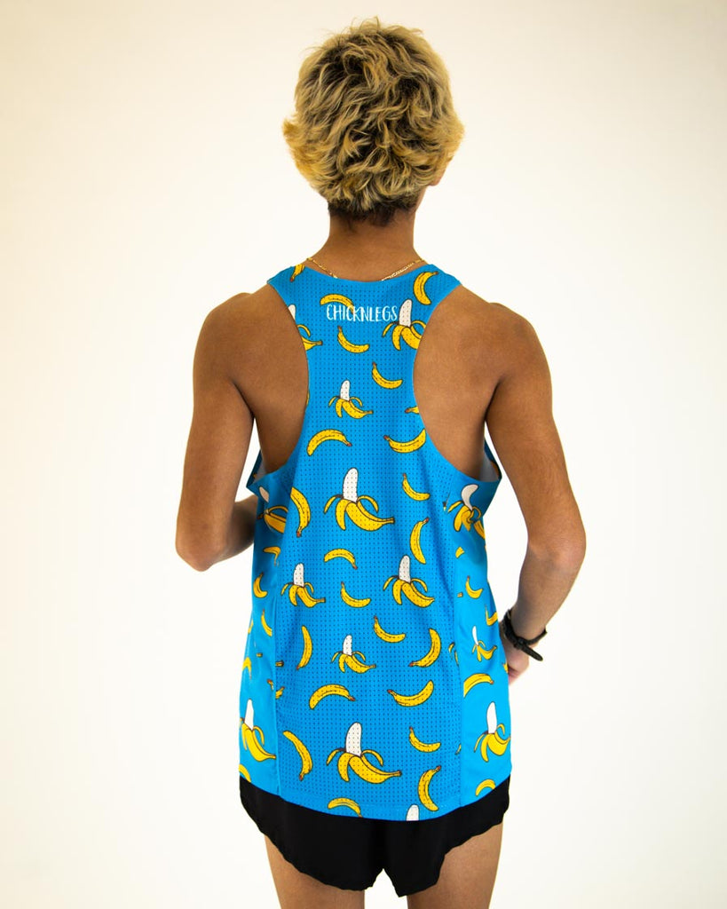 Runner is wearing ChicknLegs men's performance singlet in the blue banana design. While also wearing men's 2 in split running shorts in the black design.