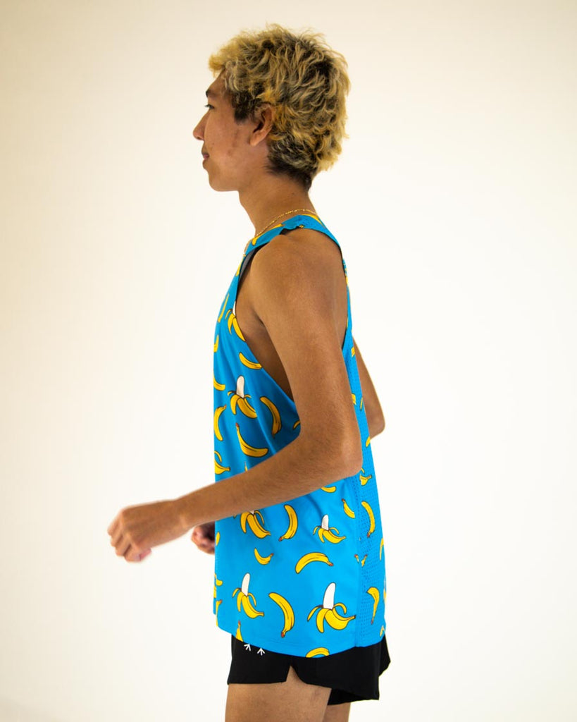 Runner is wearing ChicknLegs men's performance singlet in the blue banana design. Great for runners who love bananas!