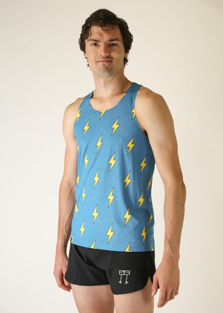 Model wearing Chicknlegs men's performance singlet wearing blue bolts design facing left.