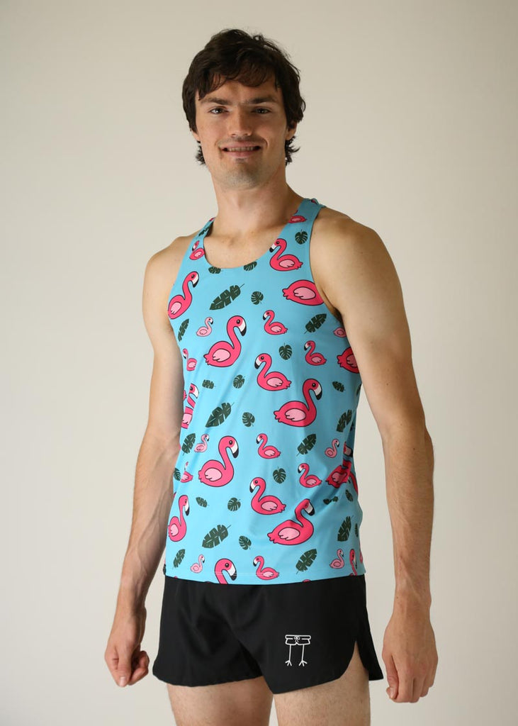 Model wearing Chicknlegs men's performance singlet wearing blue flamingo design left side view.