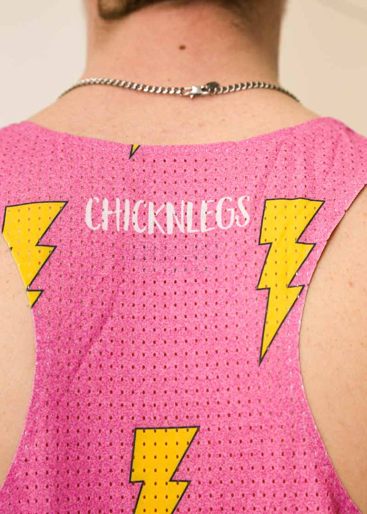 Closeup view of the back of the men's pink bolts singlet showing the perforated mesh paneling for breathability.