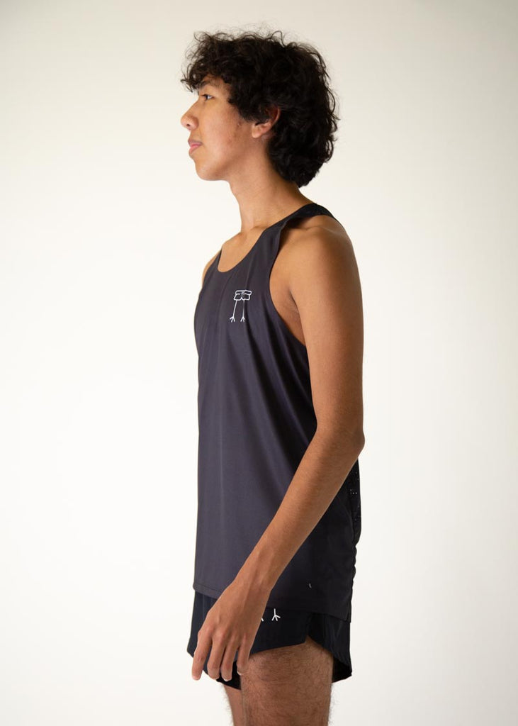 The model is a runner who is wearing Chicknlegs men's running performance singlet in the black design, facing left.