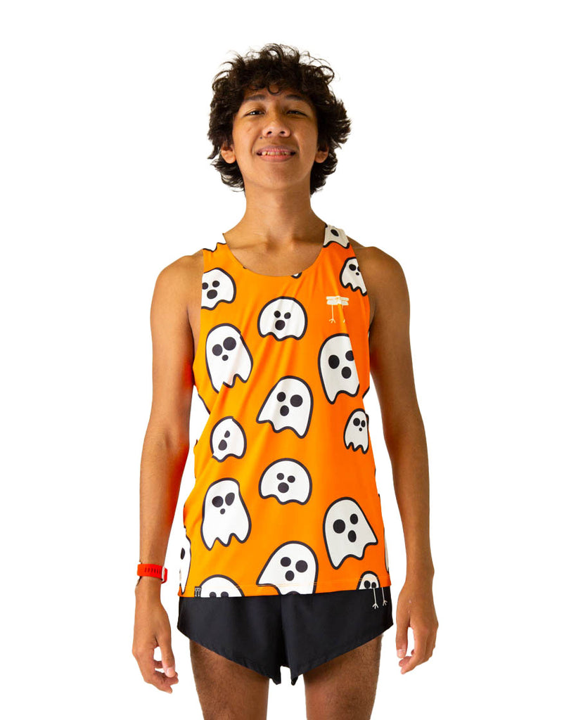 Runner is wearing ChicknLegs in the men's performance running singlet in the ghosts design. Orange fabric background with white ghosts are shown on the print.