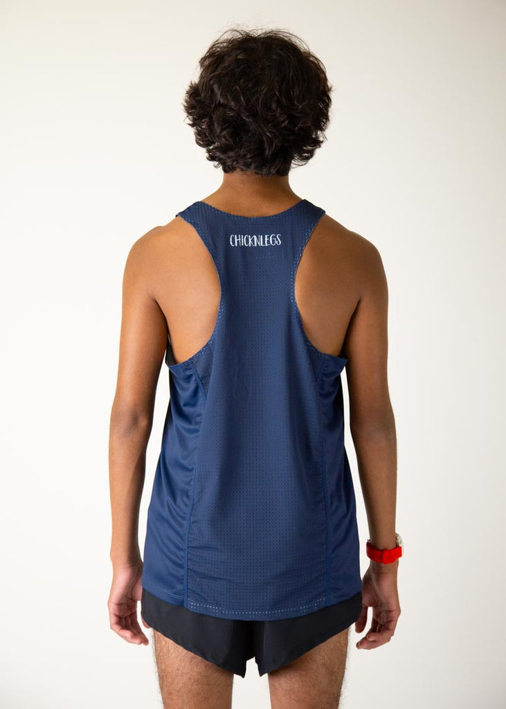 The model is a runner who is wearing Chicknlegs men's running performance singlet in the navy design, facing away from the camera to show the back of the singlet