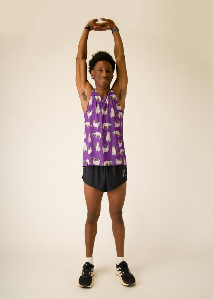 Model is wearing Chicknlegs men's runner singlet in the Sloth design, facing front while posing and lifting up arms like a sloth.