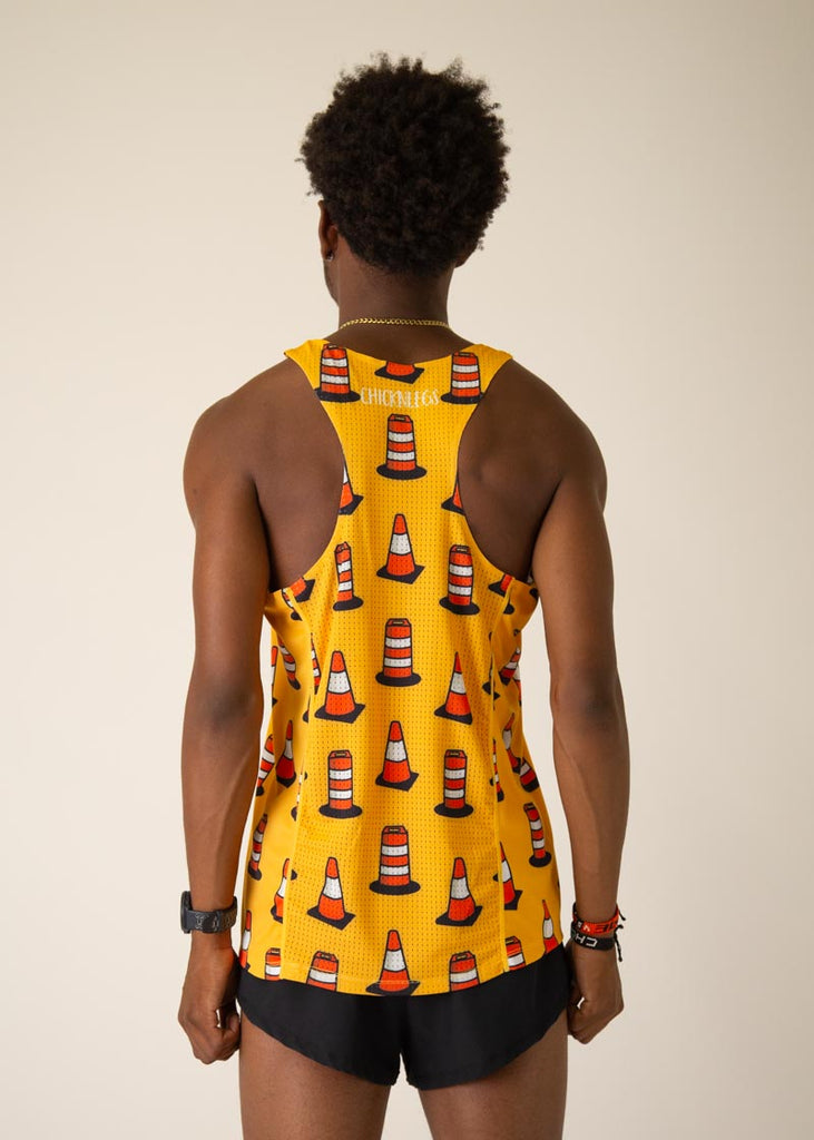 Model is wearing Chicknlegs men's runner singlet in the Traffic Cones design, facing  away from the camera to see the back view of the singlet.