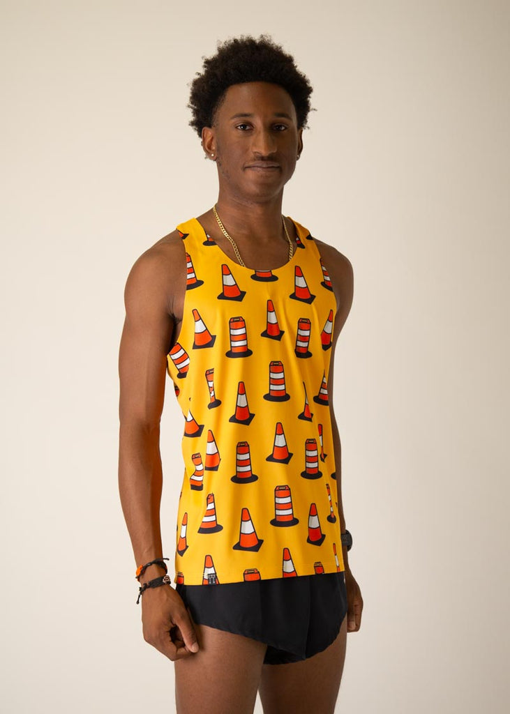 Model is wearing Chicknlegs men's runner singlet in the Traffic Cones design, facing  right.