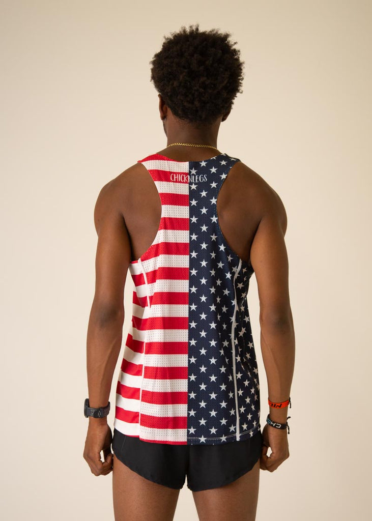 Model is wearing Chicknlegs men's runner singlet in the USA design, facing away from the camera to show the back view of the singlet.