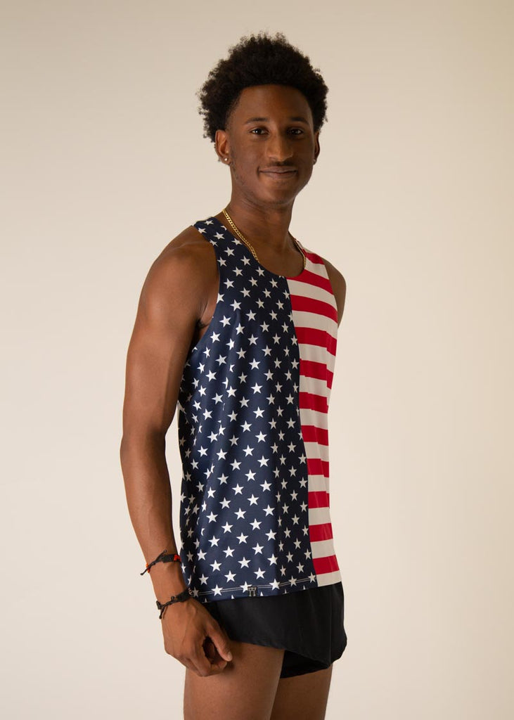 Model is wearing Chicknlegs men's runner singlet in the USA design, facing right.