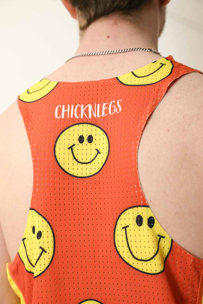 Closeup back view of the men's smiley face singlet featuring the perforated mesh paneling for breathability.
