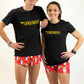 Runners wearing the men's and women's performance tees with matching burrito running shorts.