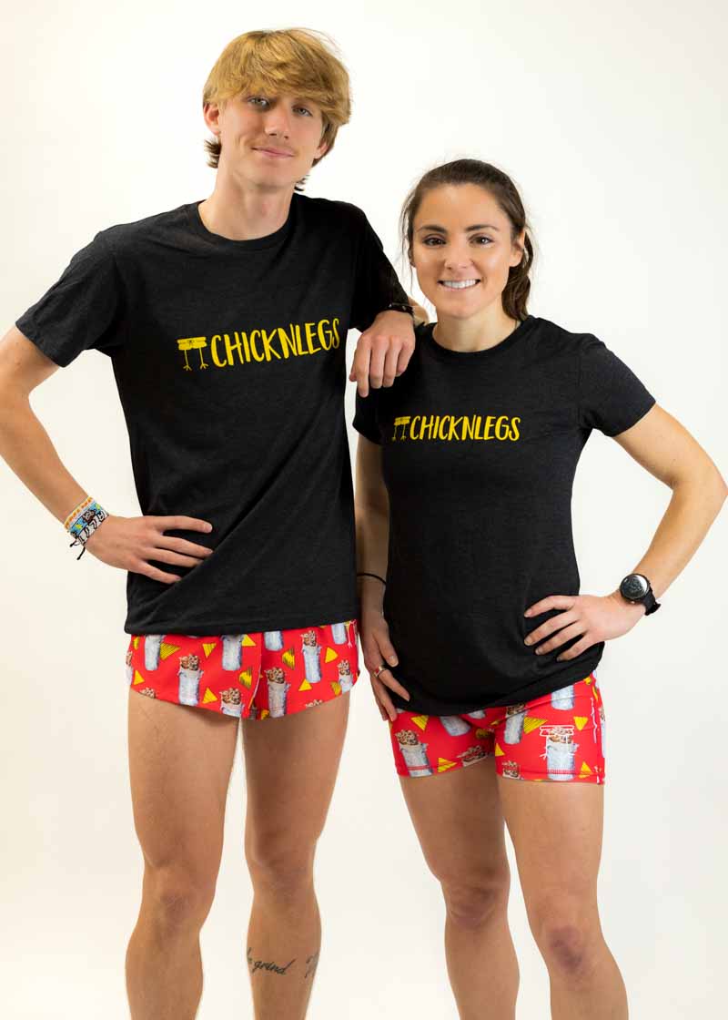Runners wearing the men's and women's performance tees with matching burrito running shorts.