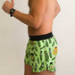 Side closeup view of the men's 4 inch split running shorts with a green pickle design.