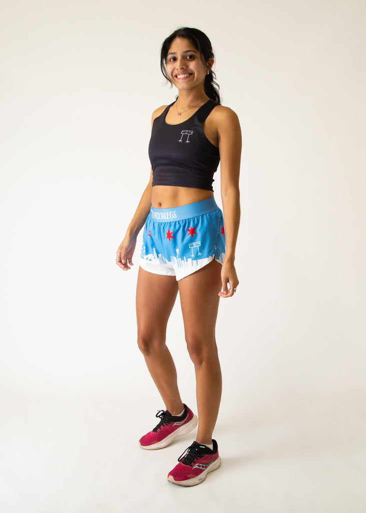 Runner is wearing ChicknLegs women's 1.5 in split running shorts in the Chicago  Style Skyline athletic shorts. It has the city and stars on it that is great for marathons.
