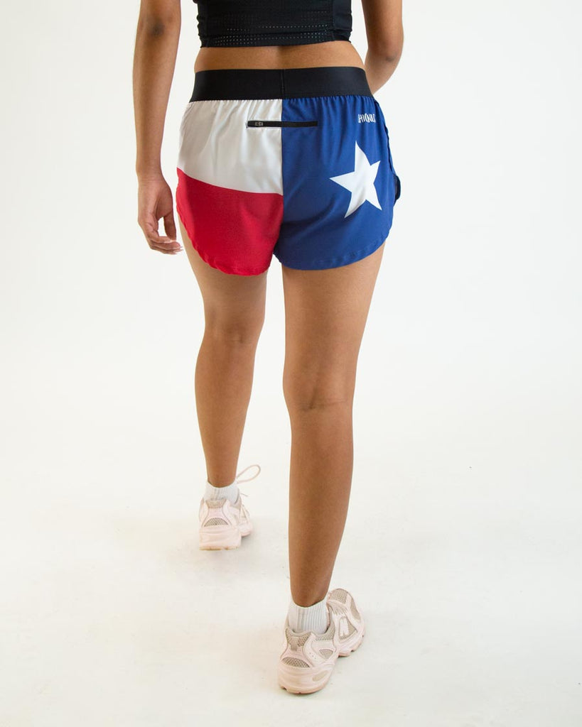 Runner is wearing ChicknLegs in the women's 1.5 in split running shorts in the texas flag print. It has blue, red and white on it. Great for runners who love their states!