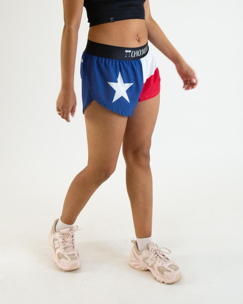 Runner is wearing ChicknLegs in the women's 1.5 in split running shorts in the texas state flag print. It has blue, red and white on it.