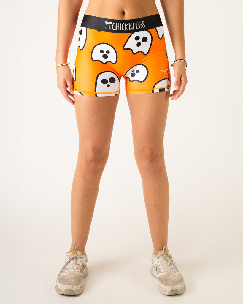 Runner is wearing ChicknLegs in the women's 3 in compression spandex shorts in the ghost design. The print has white ghosts on it with an orange background, great for halloween or any holiday.