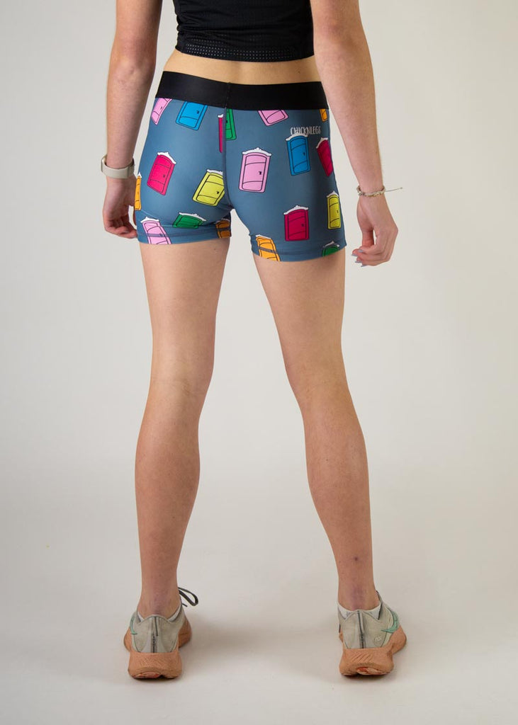 The model is a runner who is wearing Chicknlegs women's 3" compression shorts in the porta potty design, facing away from the camera to show the back of the compression.