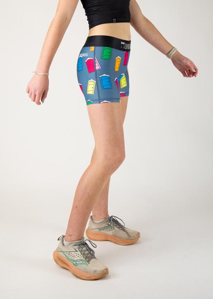 The model is a runner who is wearing Chicknlegs women's 3" compression shorts in the porta potty design, facing right.